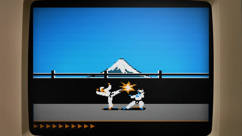 Karateka on Apple II, showing a character in a gi kicking another with a mountain backdrop